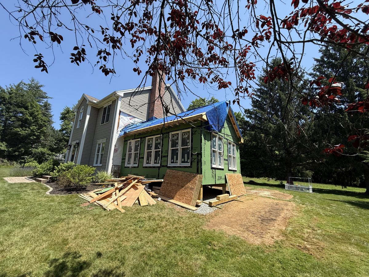 Rear addition sheathed in ZIP panels on a colonial