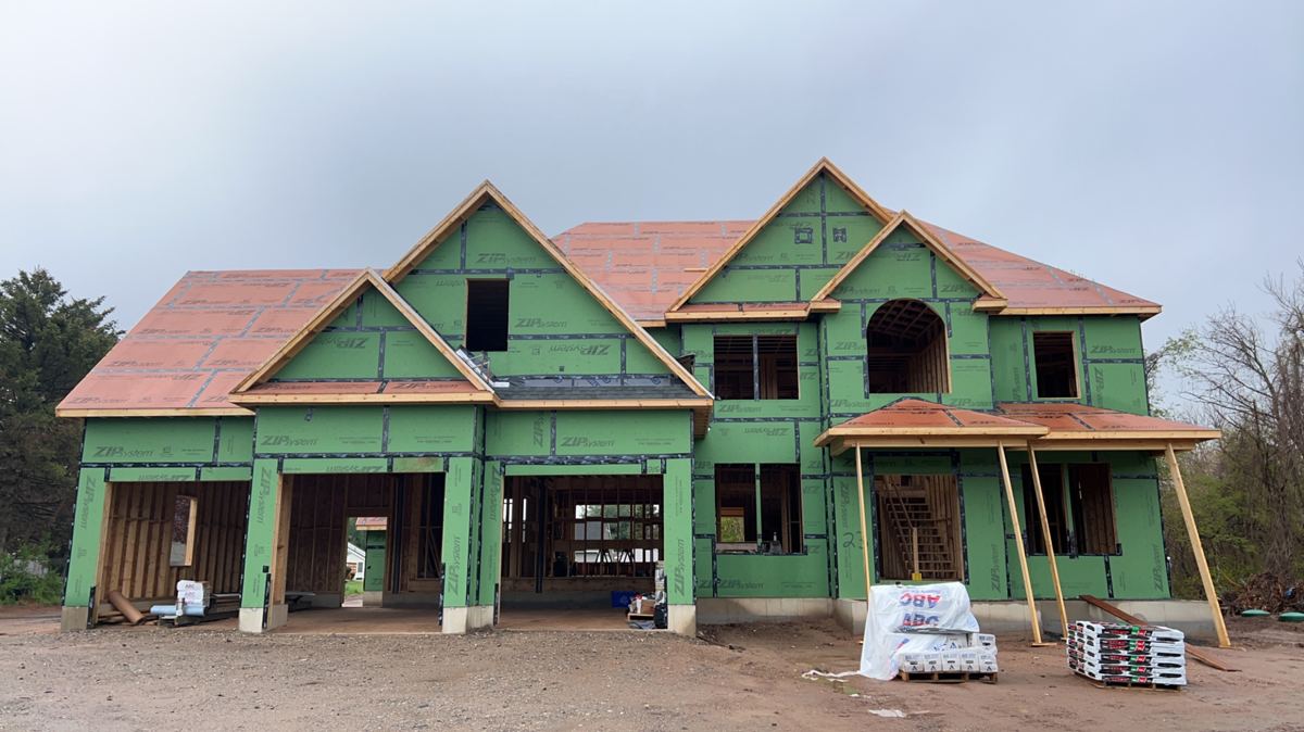 Large two-story colonial sheathed in ZIP with roof underlayment
