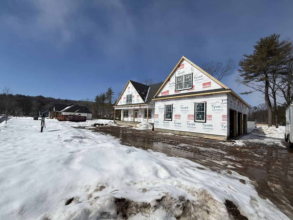 New build wrapped in Tyvek surrounded by snow